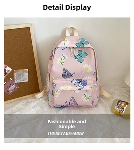Pink backpack with colorful butterfly and daisy prints on white lace tablecloth