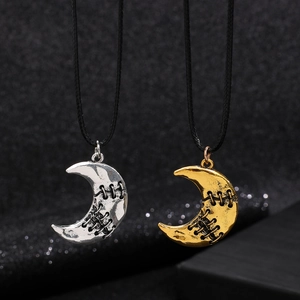 Gothic crescent moon necklaces in gold and silver with unique stitched texture on black cord