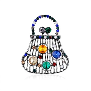Macro detail of retro handbag brooch with colorful rhinestones and antique silver finish