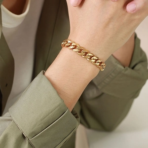 Detailed view of the gold-plated stainless steel Cuban link bracelet worn on wrist