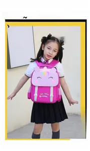 Detail of cute unicorn embroidery and rainbow stripes on a rose red school backpack