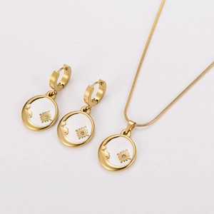 Detail of gold sun and moon necklace set with white shell inlay and sparkling crystals