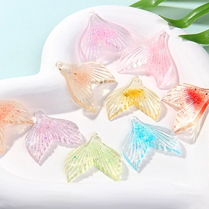 Macro view of colorful glitter resin mermaid tail charms for DIY jewelry making