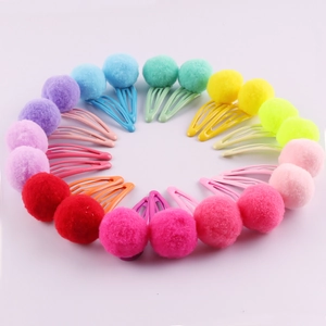 Set of 20 colorful plush pom pom hair clips for girls in candy colors on pink background