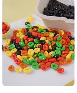 Macro shot of colorful resin coffee bean models on a white table for DIY crafts