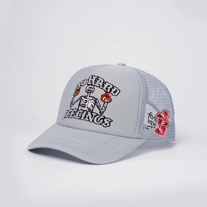 Detail of grey trucker hat featuring dead hearts embroidery and breathable mesh texture