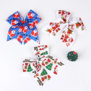 Three Christmas theme bow hair ties with festive Santa and tree prints on ribbed ribbon