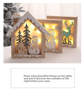 Detail of wooden Christmas LED lantern with reindeer cutout and warm glowing light