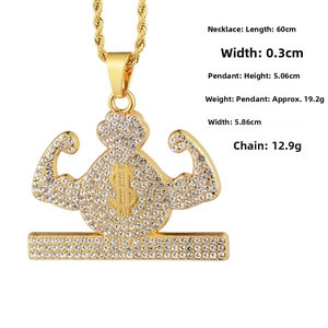 Detailed view of hip hop dollar sign pendant with muscular arms and iced-out rhinestones