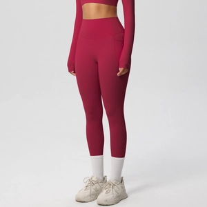 Detail of high-waist wine red yoga leggings with side pockets and premium knit texture
