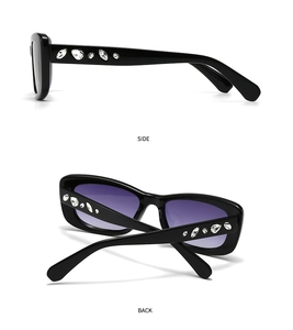 Detail view of black square sunglasses with purple gradient lenses and rhinestone temples