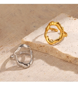 Detailed close-up of 18K gold and silver rings with irregular organic texture on stones