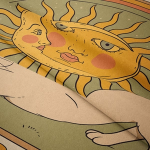 Close-up of bohemian tapestry fabric showing vintage sun and moon face pattern details