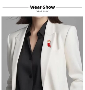 Detail showing Santa Claus in a Christmas stocking brooch on a white suit lapel
