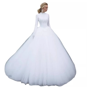 Elegant white lace ball gown wedding dress with high neck, long sleeves, and full tulle skirt