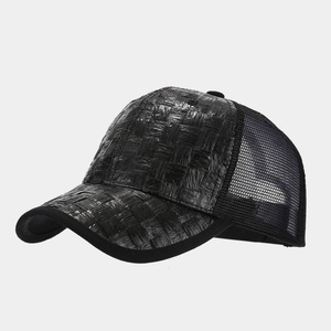 Close-up of black straw woven texture and breathable mesh on a trucker cap