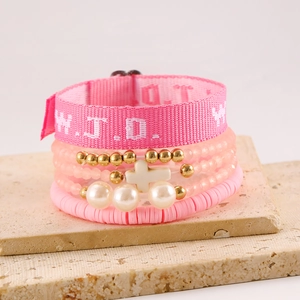 Detail of pink WWJD beaded bracelet set with cross pendant and artificial pearls