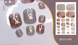 Macro detail of brown and grey gradient toe nail stickers with silver foil and gold glitter