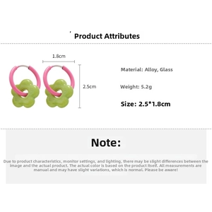 Detail view of pink hoop earrings with light green glass flowers showing size and weight