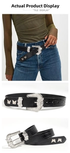 Detail of crocodile embossed leather belt with silver butterfly buckle and rhinestone studs