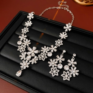 Detailed view of silver flower jewelry set with sparkling crystal waterdrop pendants