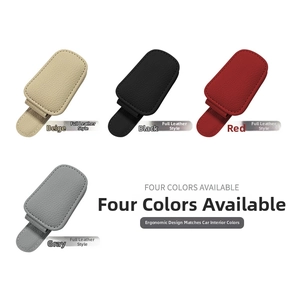 Detail view of car visor sunglasses clips in beige, black, red, and gray leather