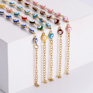 Detailed view of colorful 18K gold-plated evil eye bracelets with vibrant enamel beads