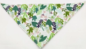 Detail of pet bandana featuring green leaves and red berry patterns with yellow stitching