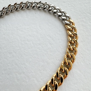 Detail of 9mm two-tone silver and 18k gold plated stainless steel cuban link chain