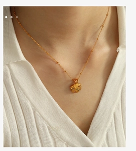 Nahaufnahme der 18K Gold-Edelstahl-Halskette mit Muschel-Anhänger und bunten Zirkonia-Steinen
