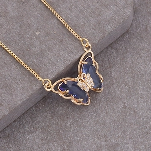 Detailed view of an 18K gold necklace featuring a vibrant blue gemstone butterfly pendant