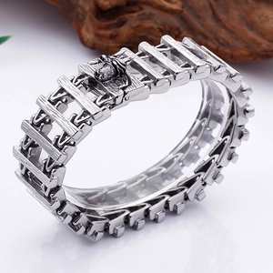 Detailed macro view of vintage silver punk dragon scale bracelet with animal head clasp