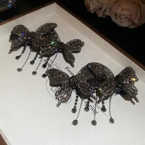 Sparkling butterfly hair clips with tassels and rhinestones in dark grey finish