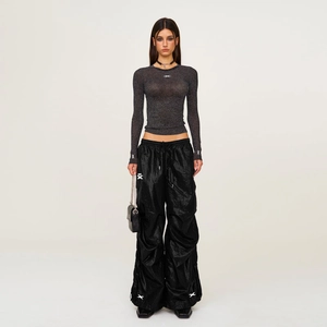 Detailed shot of dark grey slim knit top with metallic glitter and mesh texture