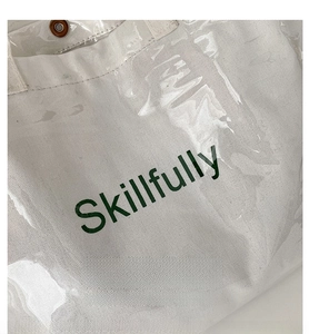 Detail view of canvas bag with transparent PVC layer and Skillfully letter printing