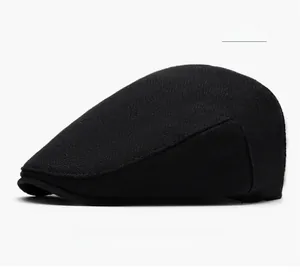 Side view detail of a classic black newsboy cap in durable wool blend twill fabric