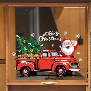 Christmas window stickers featuring a red truck, Santa, and tree in a warm indoor setting
