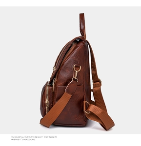 Seitenansicht des braunen Retro-Rucksacks mit Kieselmaserung und goldenen Metallschnallen