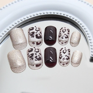 Short square press-on nails with leopard print and champagne gold glitter shimmer