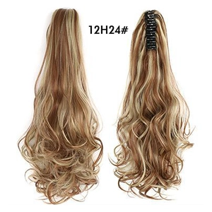 Macro detail of brown blonde wavy ponytail extension with claw clip attachment