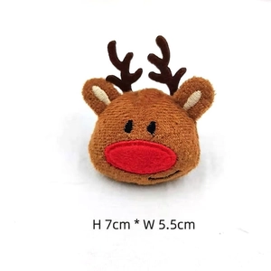 Detail view of plush Christmas reindeer brooch with dimensions 7cm height and 5.5cm width
