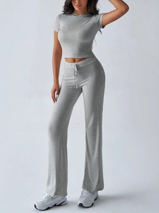 Detail of grey two-piece lounge set featuring cropped t-shirt and wide-leg joggers