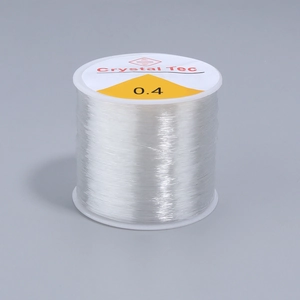 Detail of 0.4mm clear elastic bead cord on a spool for DIY jewelry making