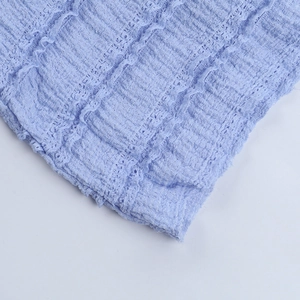 Detail shot of light blue French vintage dress showing textured seersucker fabric and cuff