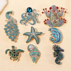 Detailed set of eight ocean-themed brooches with colorful rhinestones and enamel finishes
