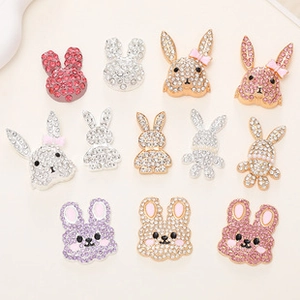 Detailed close-up of rabbit-shaped DIY metal jewelry pendants with colorful rhinestones