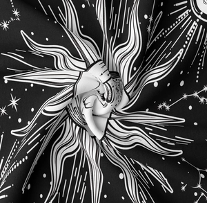 Detail of celestial tapestry fabric showing sun and stars pattern with soft texture