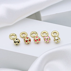 Five gold-plated enamel soccer beads with colorful heart patterns on a white silk base