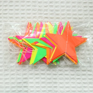 Close-up of colorful neon star garlands and hanging decorations in packaging