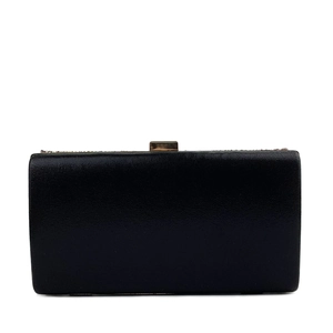 Close-up of black rectangular evening clutch with golden metal clasp and fine texture